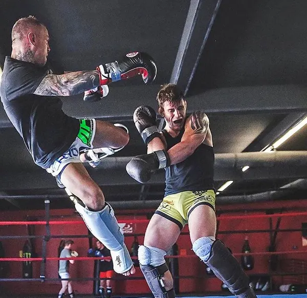 Ross Pearson throwing a kick at a training partner in the ring