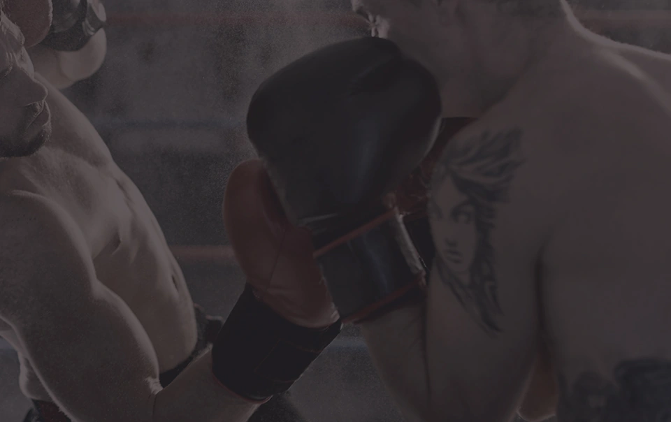 Trainer holding focus mitts for a boxer during a one on one session
